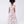 Load image into Gallery viewer, back of girls pink two-piece floral outfit with ruffle detail top and flowing wide-leg pants by Mama Luma
