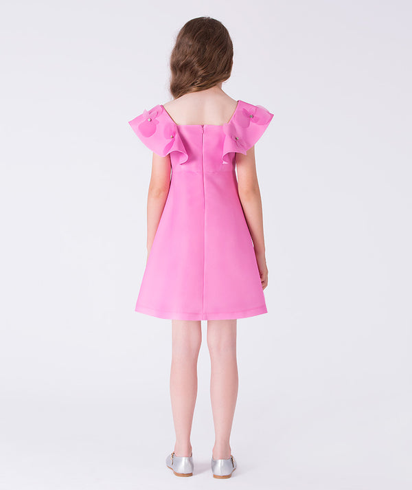 Back view of a structured pink girls occasion dress with statement ruffle shoulders and clean tailored finish for formal celebrations