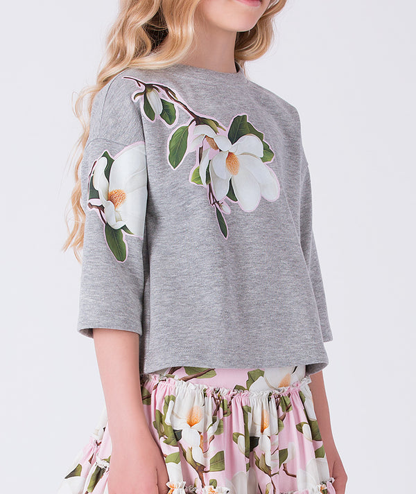 Close-up of floral ruffle top on girls skirt outfit by Mama Luma, elegant two-piece occasion set detail