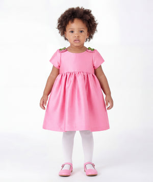 Front view of Floral Shoulder Detail Baby Dress in pink satin for babies 12 to 36 months, showing overall silhouette and styling