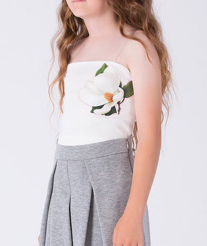 Close-up of floral appliqué strapless top on girls two-piece outfit by Mama Luma, elegant occasion wear detail