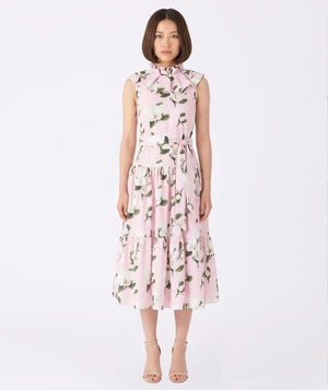 Woman wearing a pink floral dress on a white background