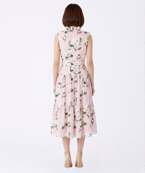Woman wearing a pink floral dress on a white background