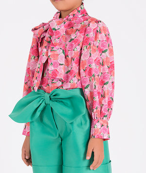 flower-printed blouse and mint shorts