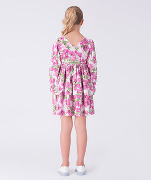 Back view of a flowy bougainvillea girls dress featuring floral print, long sleeves and relaxed silhouette for elegant occasions