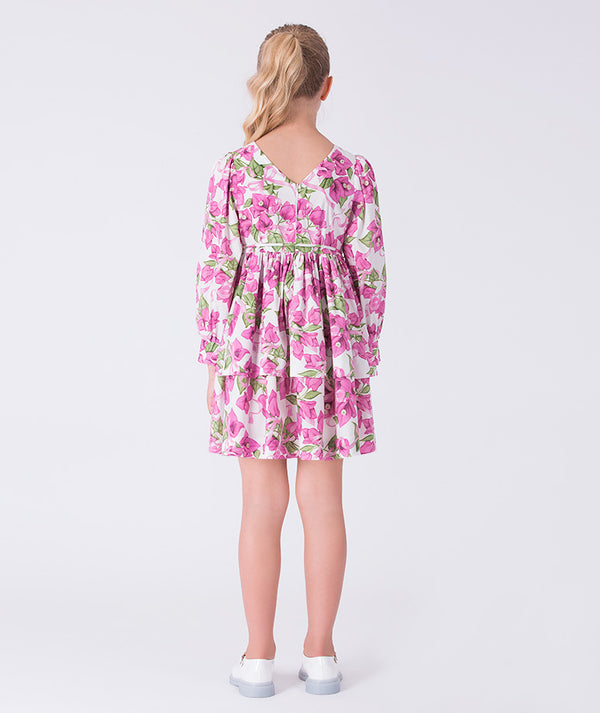 Back view of a flowy bougainvillea girls dress featuring floral print, long sleeves and relaxed silhouette for elegant occasions