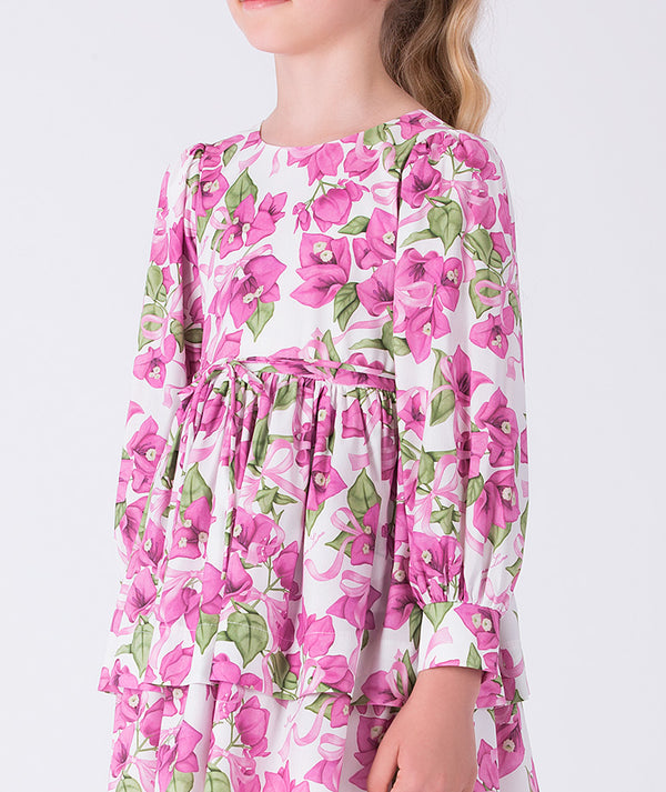 Close-up of bougainvillea floral print on a flowy girls dress with gathered waist and long sleeves, crafted for refined celebrations