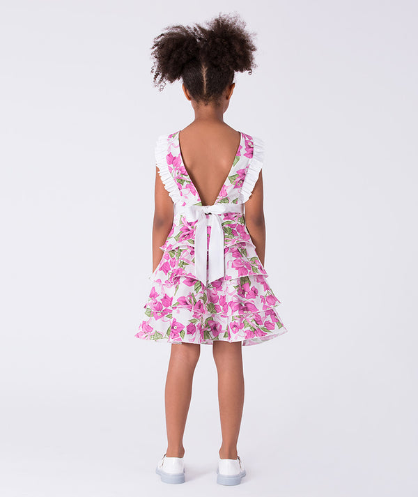 Back view of a two-piece girls outfit with open-back tie detail and layered floral skirt, designed for elegant celebrations.