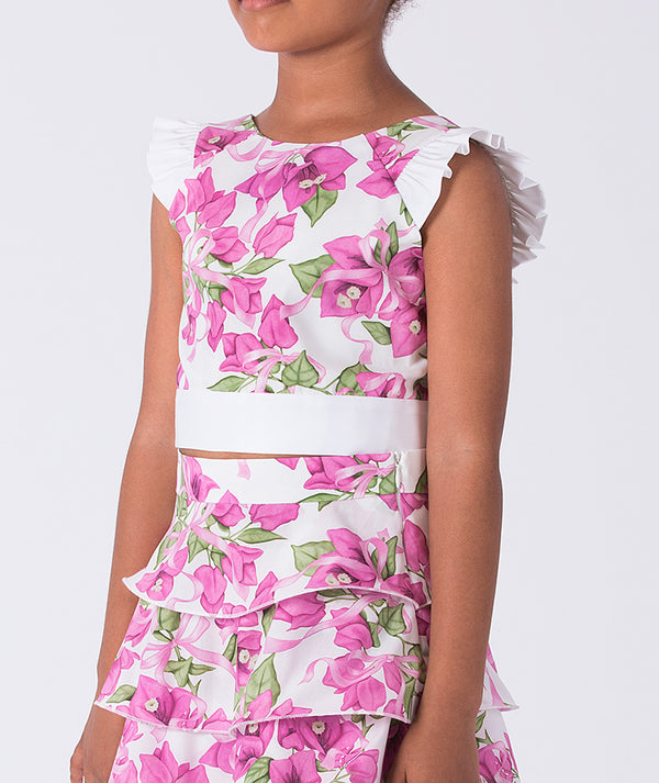 Close-up of flutter ruffle shoulder detail on a girls two-piece outfit, highlighting airy construction and refined craftsmanship.