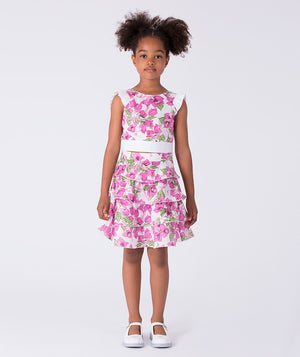 Flutter ruffle girls outfit worn by a 7-year-old girl, featuring a sleeveless top and tiered floral skirt for special occasions.