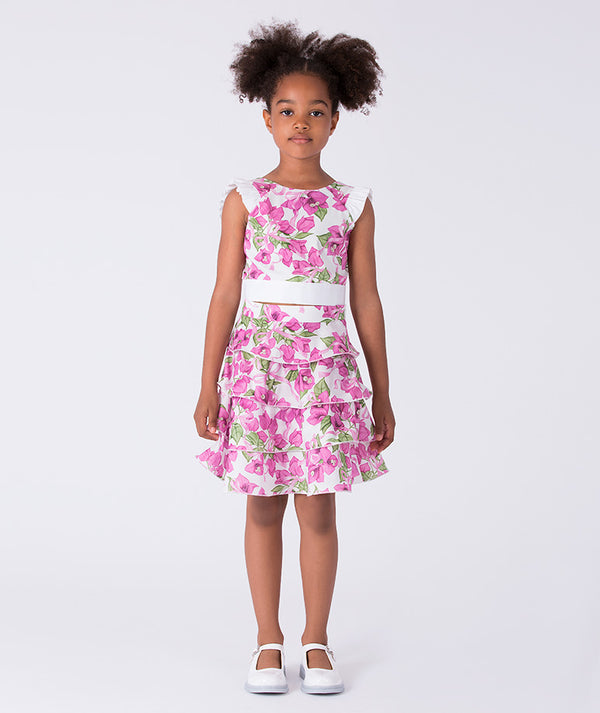 Flutter ruffle girls outfit worn by a 7-year-old girl, featuring a sleeveless top and tiered floral skirt for special occasions.