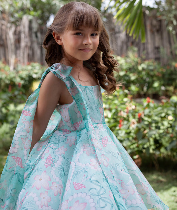 Girl in a mint floral fit-and-flare dress in a garden