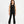 Load image into Gallery viewer, Front-facing lifestyle image of a girl wearing a black sleeveless tank top with matching flared pants, styled for confident everyday outfits, modern comfort, and relaxed movement, available in sizes 3–14
