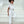 Load image into Gallery viewer, Girls ivory formal jumpsuit with wide-leg silhouette and sheer tulle ruffle collar, styled for weddings, special ceremonies, family celebrations, and elegant formal occasions, available in sizes 3–12
