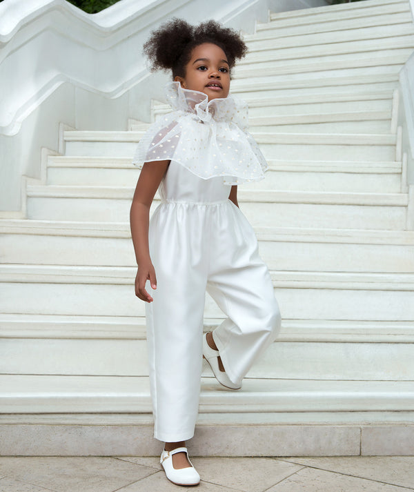 Girls ivory formal jumpsuit with wide-leg silhouette and sheer tulle ruffle collar, styled for weddings, special ceremonies, family celebrations, and elegant formal occasions, available in sizes 3–12