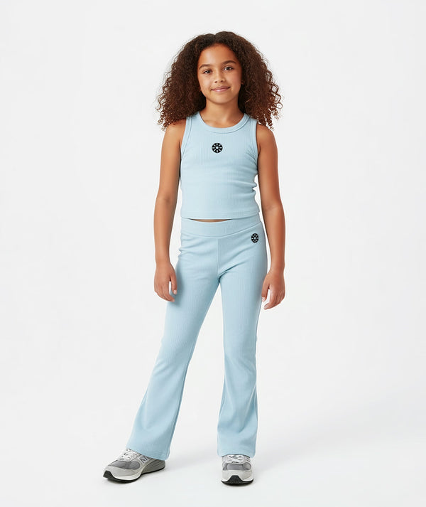 Front-facing lifestyle image of a girl wearing a light blue sleeveless ribbed tank with coordinating flared pants, styled for breathable summer outfits, relaxed movement, and everyday comfort, available in sizes 3–14