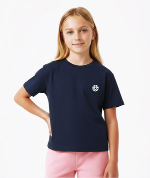 Front-facing lifestyle image of a girl wearing a navy short sleeve t-shirt styled with pink bottoms, designed for clean everyday outfits, school-friendly comfort, and relaxed daily wear, available in sizes 3–14