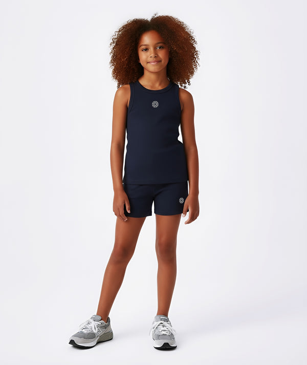 Girl wearing a navy sleeveless tank top and matching navy shorts, styled for everyday athleisure, school days, and active play, available in sizes 3–14