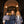 Load image into Gallery viewer, Three girls model navy special occasion dresses and tailored blue tweed outerwear in a festive entryway
