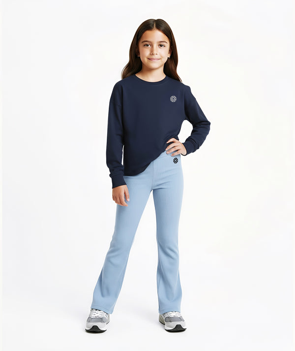 Girl wearing a navy sweatshirt and light blue ribbed pants, styled for everyday athleisure, school days, and active play, available in sizes 3–14