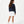Carica l'immagine nel visualizzatore Galleria, Three-quarter back lifestyle image of a girl wearing a navy sweatshirt with white shorts, styled for transitional weather outfits, casual school wear, and relaxed daily movement, available in sizes 3–14
