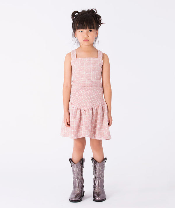 Front view of Bouclé Tweed Girls Outfit in blush pink tweed, sleeveless blouse with pleated skirt, luxury two-piece outfit for girls ages 3–12y.