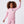 Load image into Gallery viewer, Front-facing lifestyle image of a girl wearing a pink hoodie with matching jogger pants, captured with an arm raised to highlight playful movement, everyday comfort, and active athleisure styling, available in sizes 3–14
