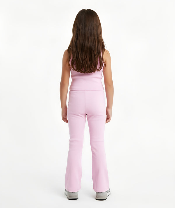 Girl seen from the back wearing a pink sleeveless tank top and matching ribbed pants, styled for everyday athleisure, school days, and active play, available in sizes 3–14