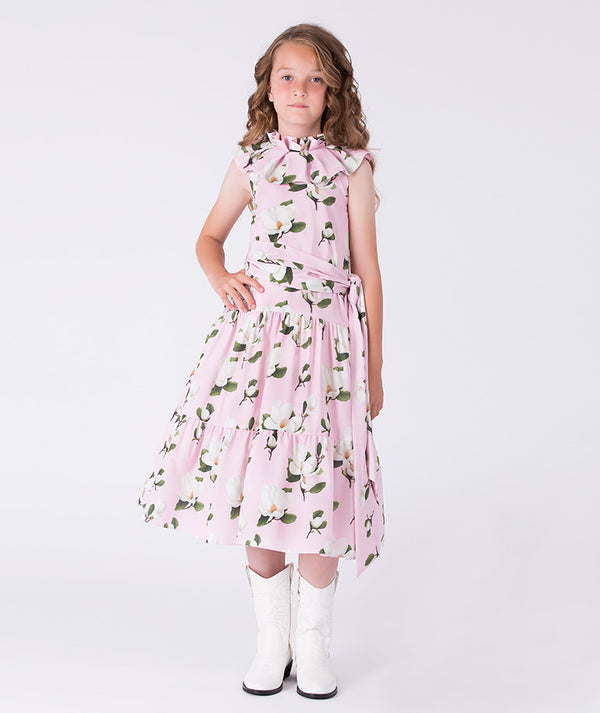 Girls floral sleeveless dress by Mama Luma featuring a ruffle neckline, tiered skirt, and waist tie, suitable for birthdays and special occasions, sizes 3–12.