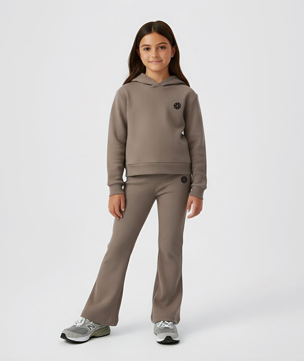 Girl wearing a taupe hoodie and matching ribbed pants, styled for everyday athleisure, school days, and active play, available in sizes 3–14