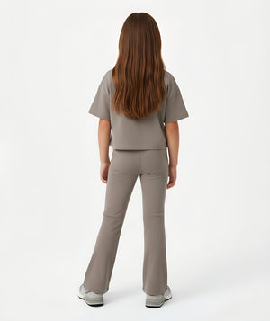 Girl seen from the back wearing a taupe short sleeve t-shirt and matching ribbed pants, styled for everyday athleisure, school days, and active play, available in sizes 3–14
