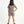 Carica l'immagine nel visualizzatore Galleria, Girl seen from the back wearing a taupe short sleeve t-shirt and matching taupe shorts, styled for everyday athleisure, school days, and active play, available in sizes 3–14
