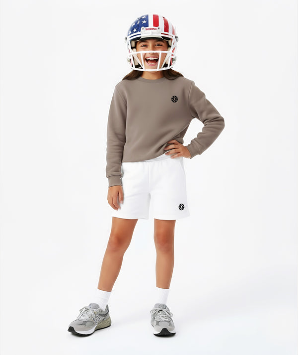 Girl wearing a taupe sweatshirt and white shorts with a sports helmet, styled for active play, sports-inspired athleisure, and everyday wear, available in sizes 3–14