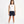 Carica l'immagine nel visualizzatore Galleria, Front-facing lifestyle image of a girl wearing a white sleeveless tank top with navy shorts, styled for warm-weather comfort, everyday movement, and casual play, available in sizes 3–14
