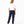 Charger l'image dans la galerie, Back-facing lifestyle photo of a girl wearing a white short sleeve t-shirt with navy jogger pants, styled for relaxed school outfits, casual movement, and daily comfort, available in sizes 3–14
