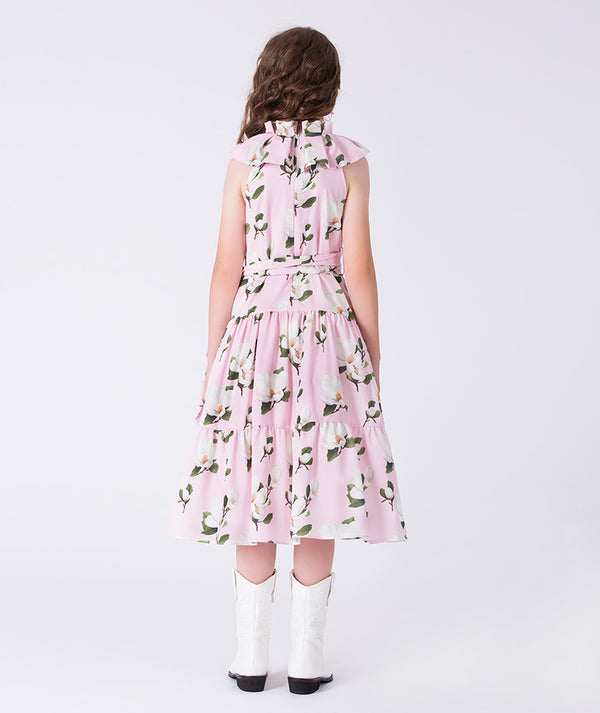 Back view of Mama Luma girls floral dress showing the flowing tiered skirt and adjustable waist tie for family gatherings and celebrations, sizes 3–12