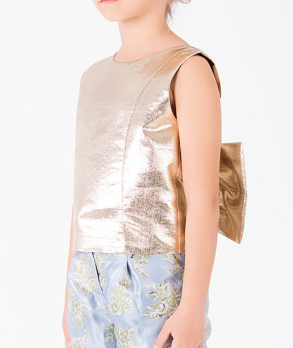 Metallic gold sleeveless girls top with statement back bow and powder blue floral jacquard trousers detail