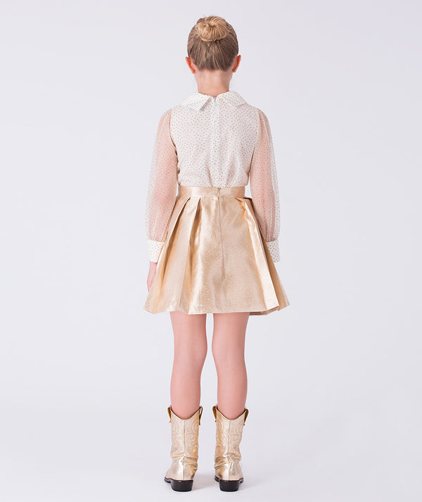 Back view of gold girls blouse and skirt set featuring sheer polka dot sleeves and metallic A-line skirt