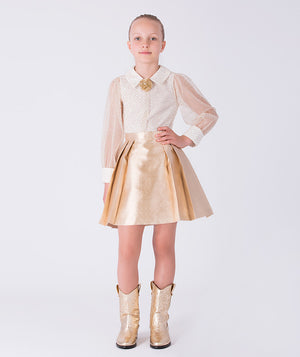 Front view of gold girls two-piece outfit with sheer long sleeve blouse and high-waisted metallic skirt
