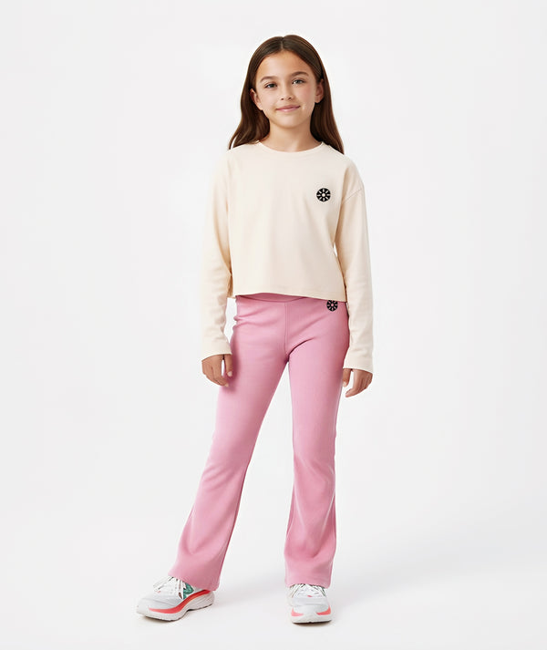 GoldenCubs girls’ beige long-sleeve crop top paired with pink flare pants, a stylish and comfy outfit perfect for school, travel, and weekend fun. Available in sizes 3–12Y.