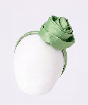 Green rose bow headband for girls by Mama Luma, styled as an elegant hair accessory for weddings, celebrations, and special occasions.