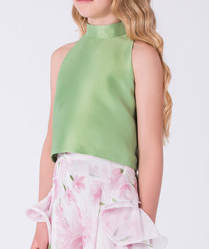 Close-up of the halter-neck top and floral ruffle pants detail on a girls outfit designed for garden parties and family gatherings.