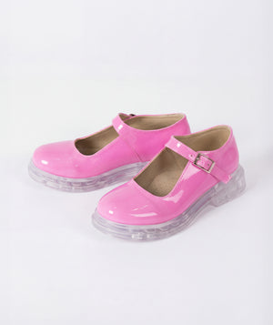 Pink shoes with clear soles on a white background