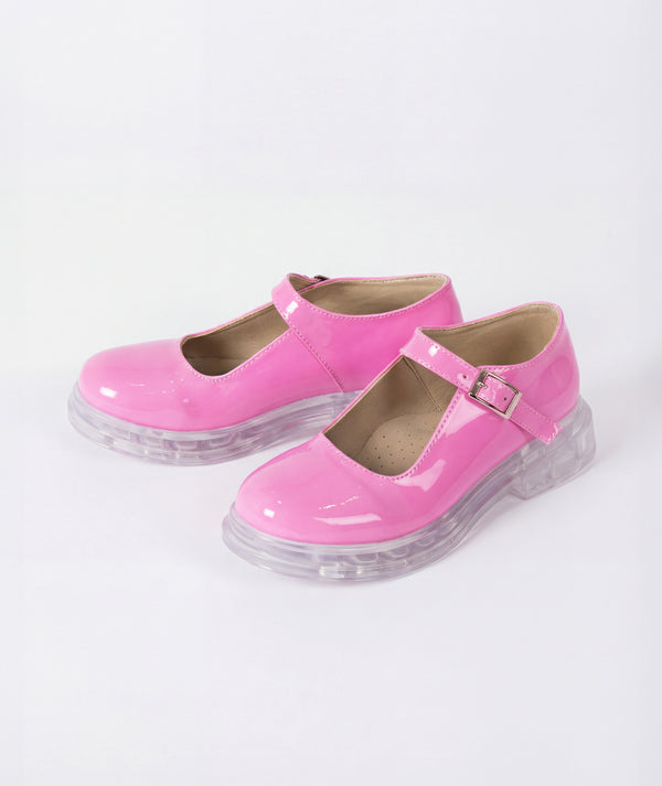 Pink shoes with clear soles on a white background