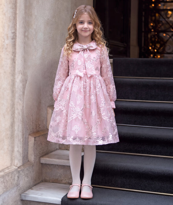 Luxury blush pink girls’ jacquard dress with metallic detailing and a crystal-centered bow for weddings and birthdays