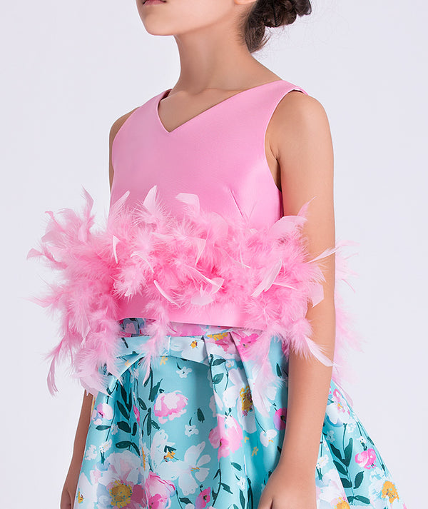 Close-up of baby blue occasion skirt featuring pink white and yellow flowers with refined pleating