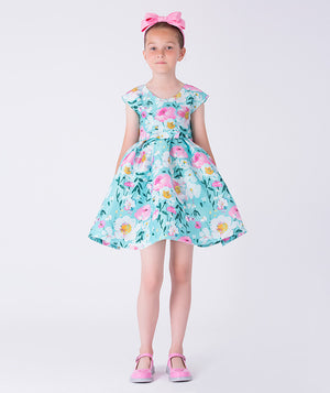 Kohana Petals Girls Dress with pastel floral print, cap sleeves, and flared skirt, front view girls occasion dress from Kohana Collection.
