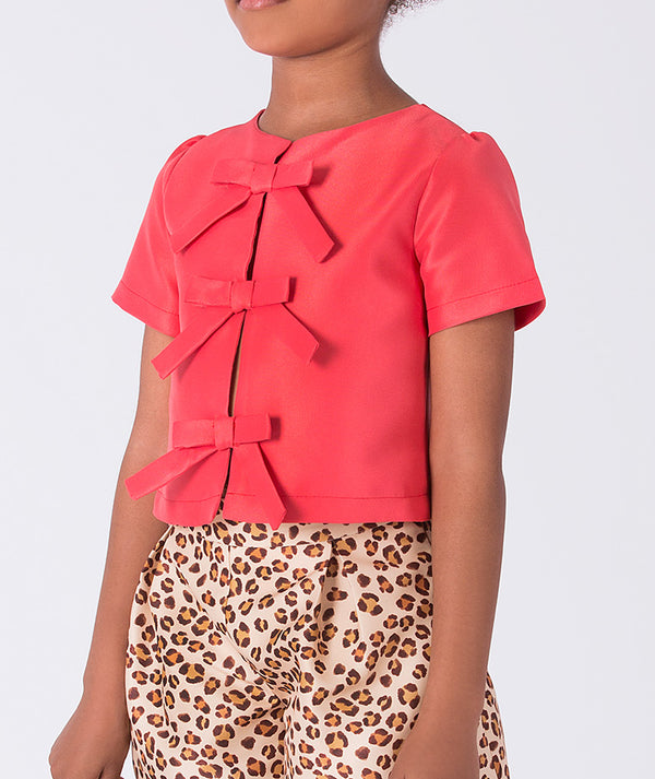Close-up detail of the Leopard Shorts Girls Outfit highlighting the decorative bow accents on the top and premium lightweight woven fabric, fully cotton lined for comfort, ideal for festive events and celebrations for ages 3–12.