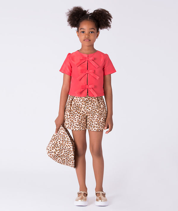 Front view of the Leopard Shorts Girls Outfit featuring a bow-detail short-sleeve top and leopard-print shorts, crafted from premium lightweight fabric with cotton lining, designed for girls ages 3–12 for birthdays and summer occasions.
