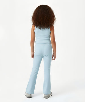 Girl seen from the back wearing a light blue sleeveless tank top and matching pants, styled for everyday activewear, movement, and casual play, available in sizes 3–14
